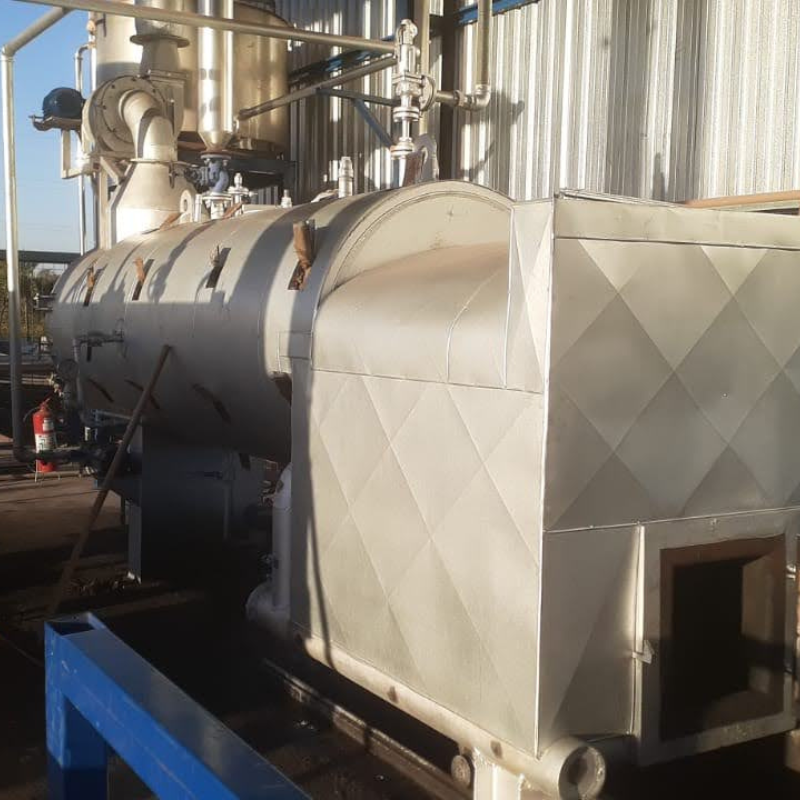 Caldeira industrial adequada às normas NR13, instalada em ambiente seguro com barreiras de proteção.