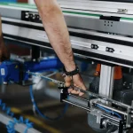 Profissional realiza ajuste mecânico em equipamento industrial durante manutenção